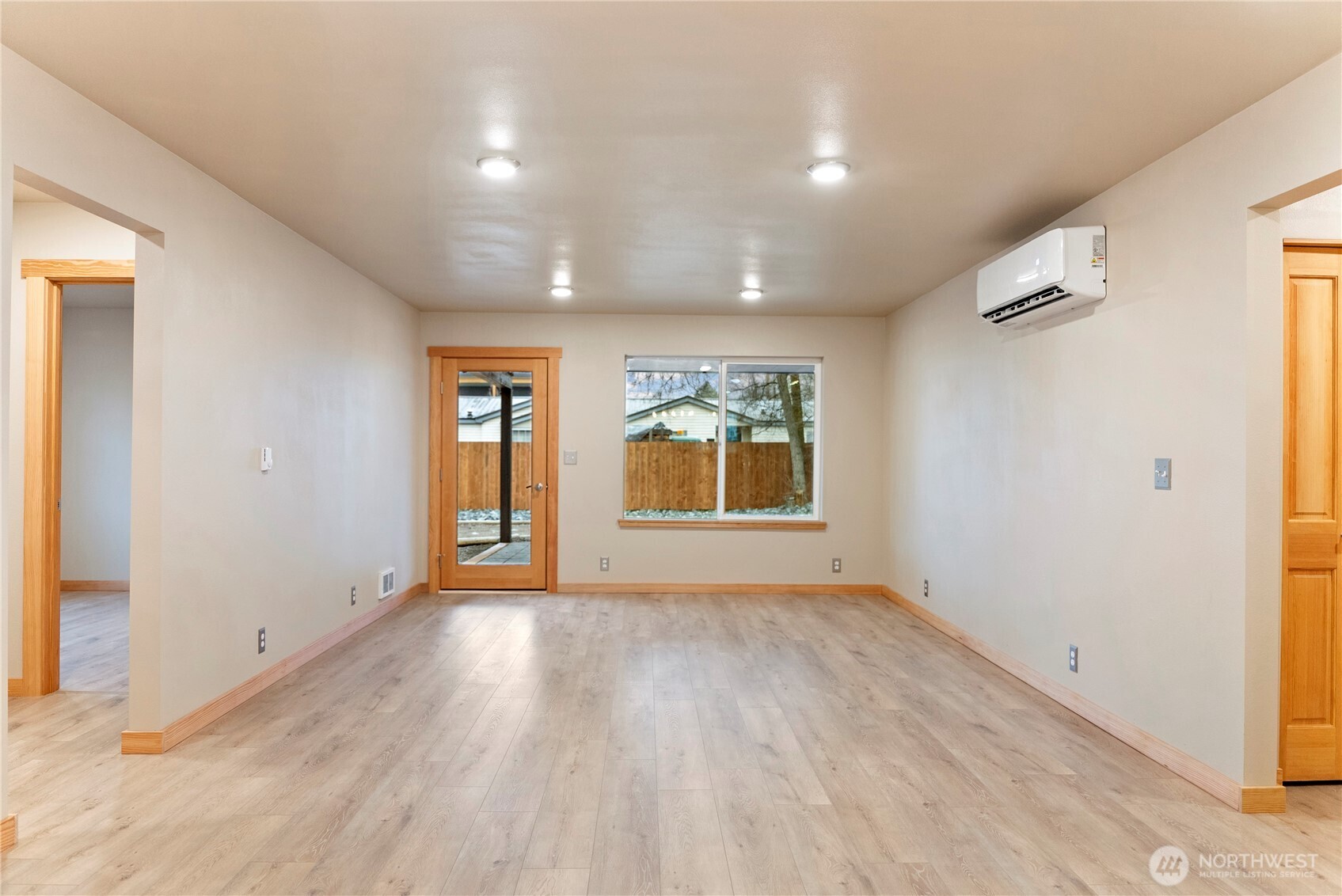 1110 Riverside Avenue Twisp, WA 98856 - Photo 11 of 28 an empty room with wooden floor and windows