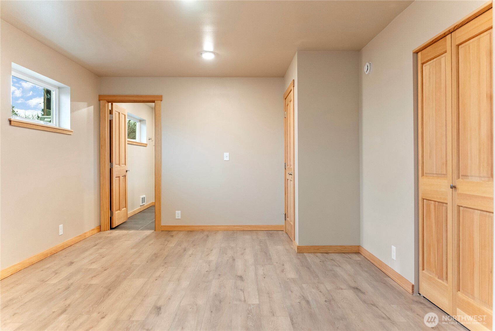 1110 Riverside Avenue Twisp, WA 98856 - Photo 14 of 28 an empty room with wooden floor and windows