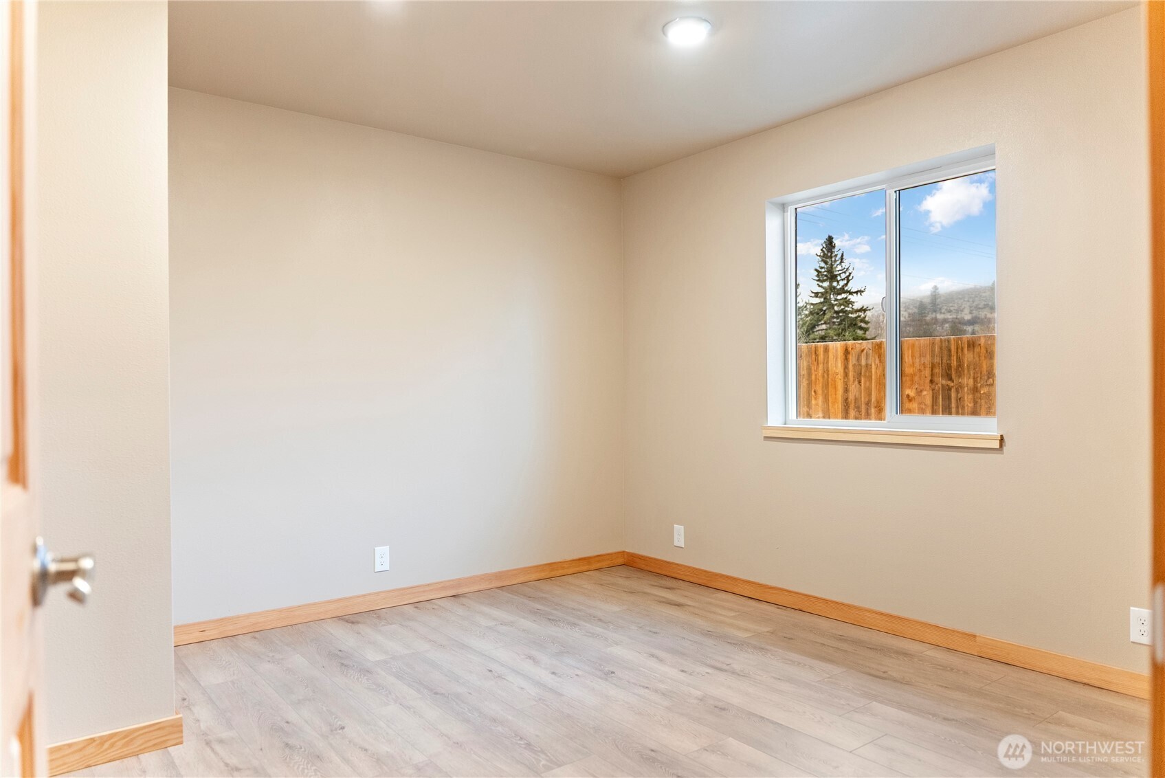 1110 Riverside Avenue Twisp, WA 98856 - Photo 18 of 28 a view of an empty room with wooden floor and a window