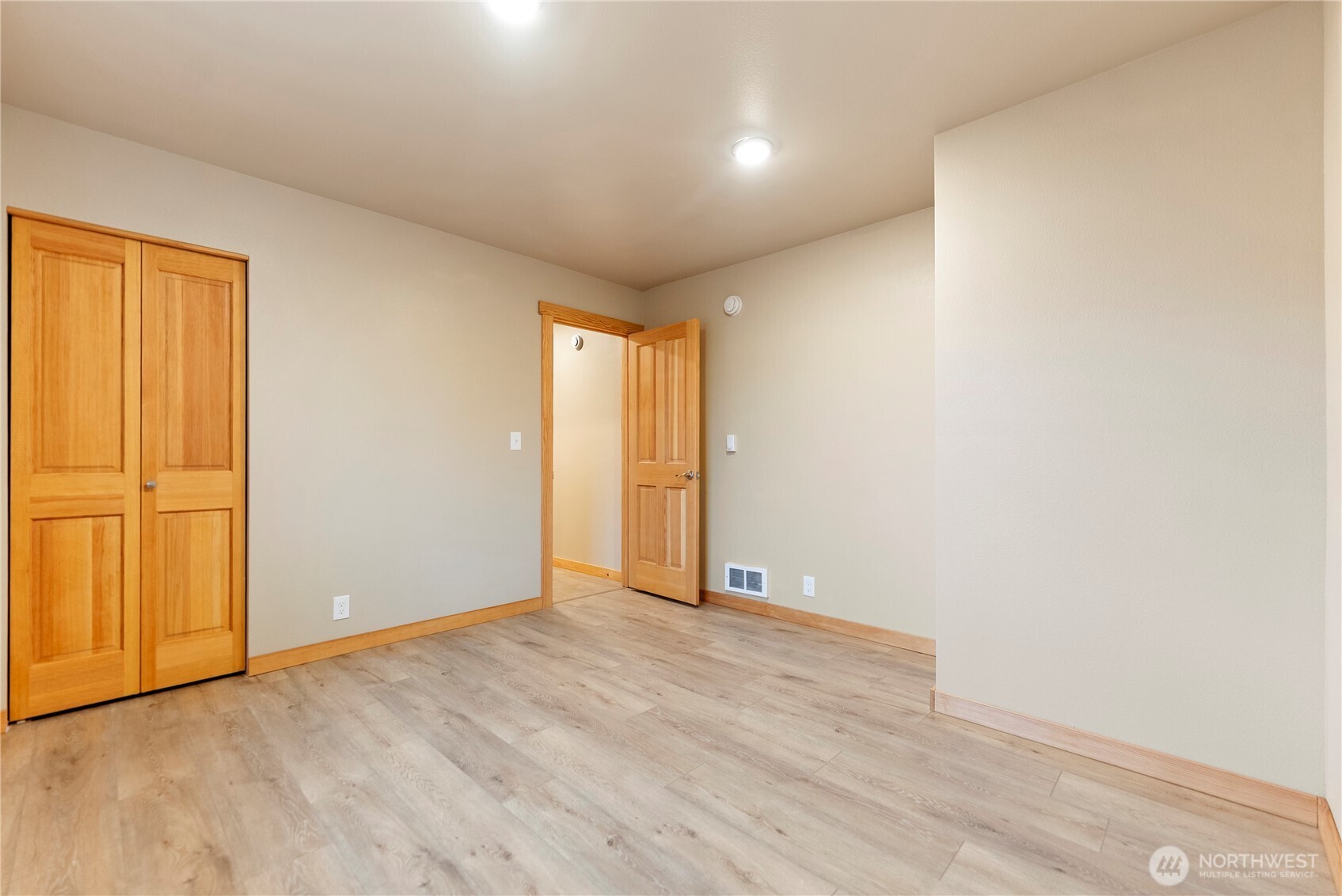 1110 Riverside Avenue Twisp, WA 98856 - Photo 19 of 28 an empty room with wooden floor and windows