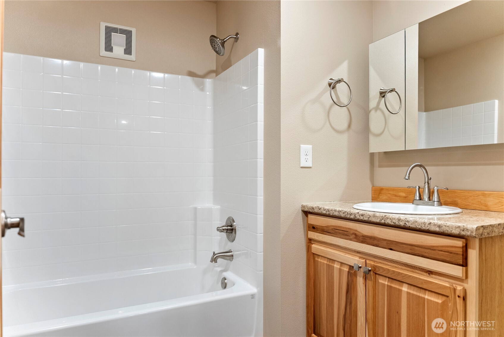 1110 Riverside Avenue Twisp, WA 98856 - Photo 20 of 28 a bathroom with a granite countertop sink a mirror and a bathtub