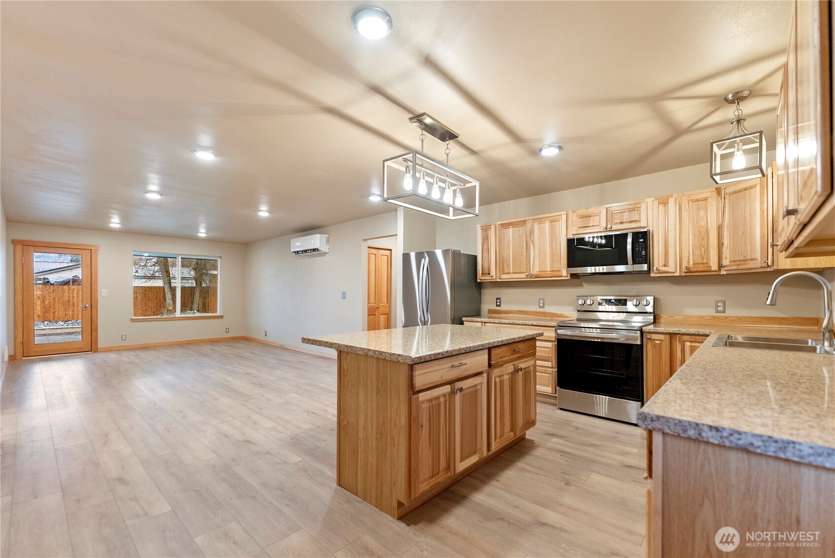 1110 Riverside Avenue Twisp, WA 98856 - Photo 10 of 28 a kitchen with stainless steel appliances granite countertop a stove top oven a sink dishwasher and a refrigerator with wooden floor