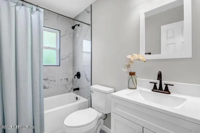 a bathroom with a sink a toilet and a bathtub