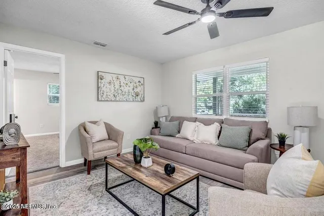 a living room with furniture and a window