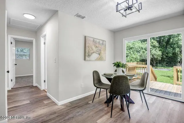 a view of a dining room with furniture window and wooden floor