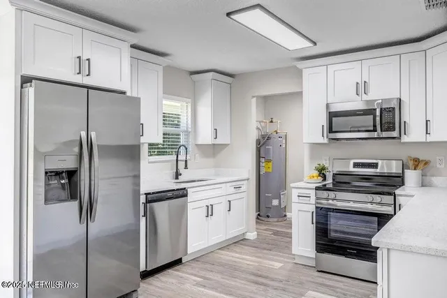 a kitchen with stainless steel appliances a refrigerator stove and microwave