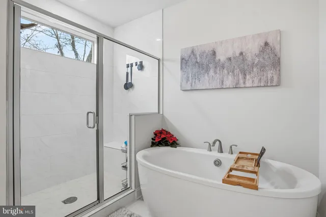 a bathroom with a tub and shower