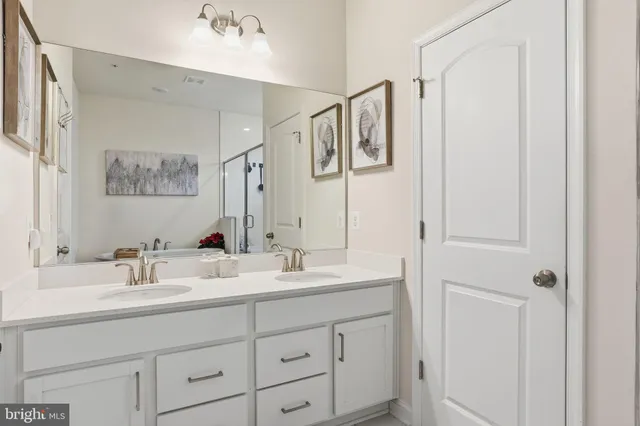 a bathroom with a double vanity sink mirror and