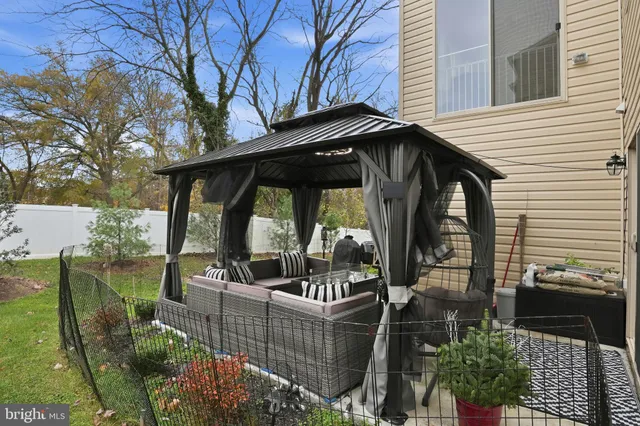 a view of a balcony with chairs and floor to ceiling window