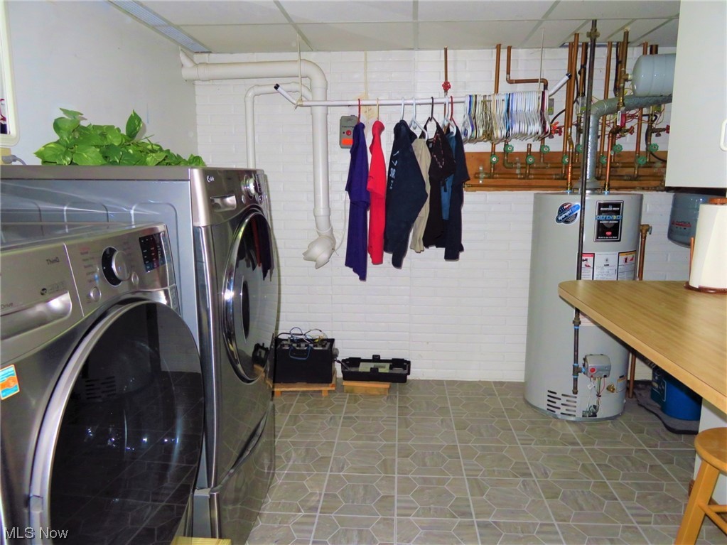 42175 Butternut Ridge Road Elyria, OH 44035 - Photo 33 of 35 The laundry room is located in the lower level as well. (6 steps down from the foyer). The LG washer & gas dryer can stay. There are hanging cabinets & a folding counter for your convenience. A utility tub was also
added in 2021, and a new vinyl tile floor was installed then too. There's a sump pump with a battery backup. The 2018 hot water tank is located in this room, as is the gas boiler system.