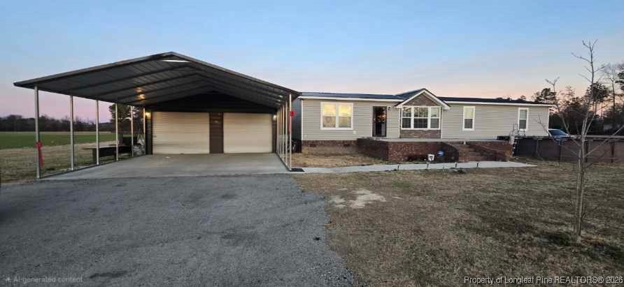 a view of a house with backyard and wooden fence