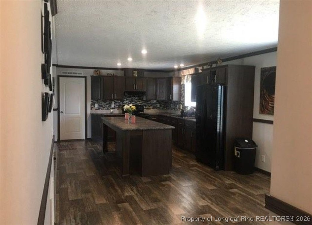 2754 Snipes Road Red Springs, NC 28377 - Photo 11 of 25 a kitchen with refrigerator and cabinets