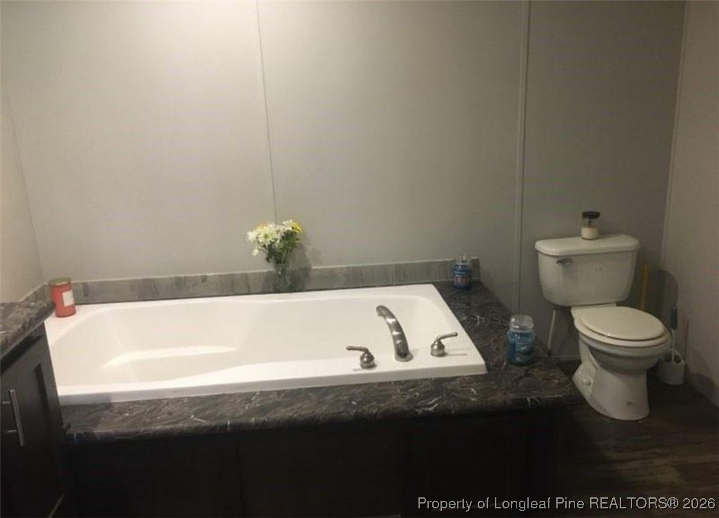 2754 Snipes Road Red Springs, NC 28377 - Photo 13 of 25 a bathroom with a toilet and a bathtub