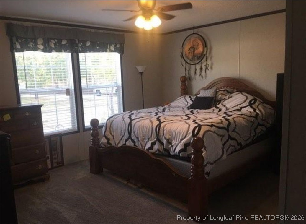 2754 Snipes Road Red Springs, NC 28377 - Photo 19 of 25 a bed sitting in a bedroom next to a window