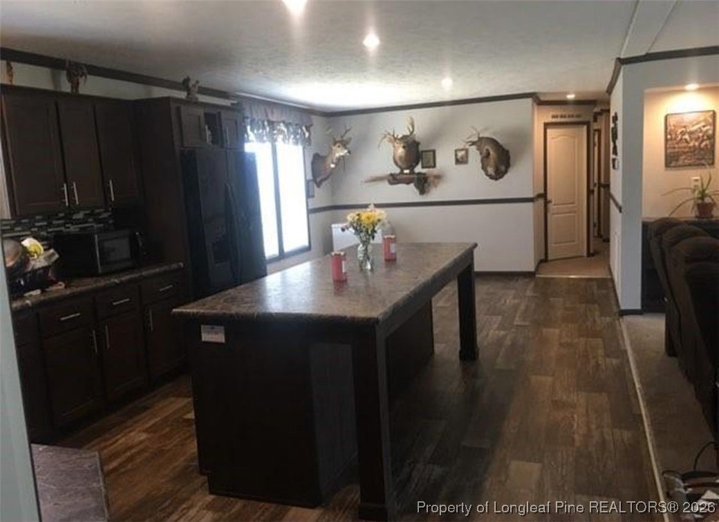 2754 Snipes Road Red Springs, NC 28377 - Photo 7 of 25 a kitchen with a sink and refrigerator