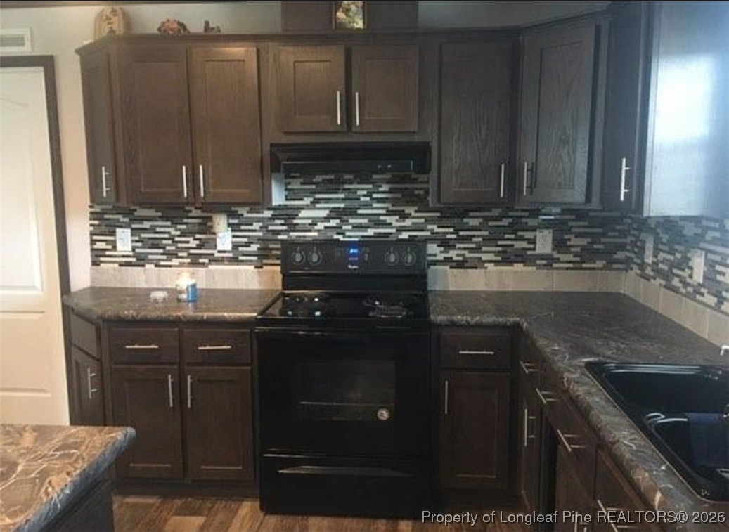 2754 Snipes Road Red Springs, NC 28377 - Photo 8 of 25 a kitchen with a sink and cabinets