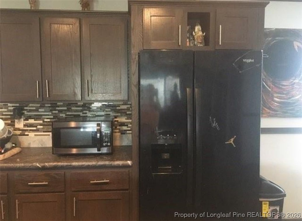 2754 Snipes Road Red Springs, NC 28377 - Photo 10 of 25 a kitchen with a refrigerator and cabinets
