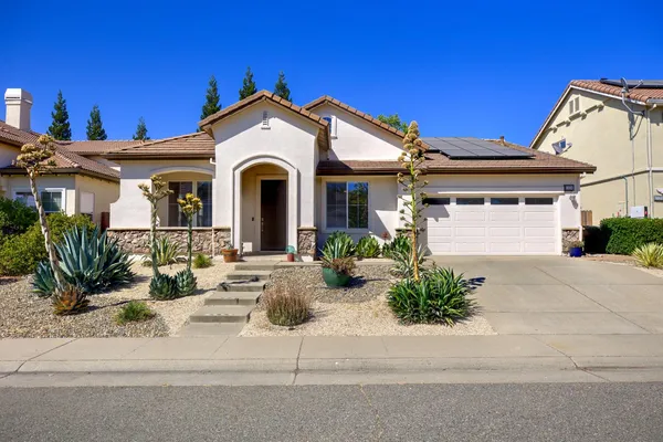 a front view of a house with garden