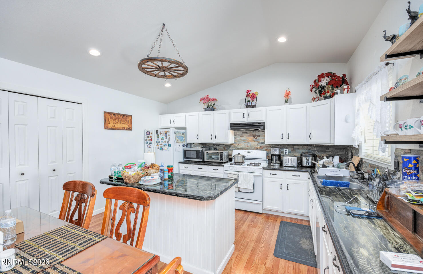 2885 Dallas Drive Fallon, NV 89406 - Photo 6 of 27 a kitchen with granite countertop lots of clutter and stainless steel appliances