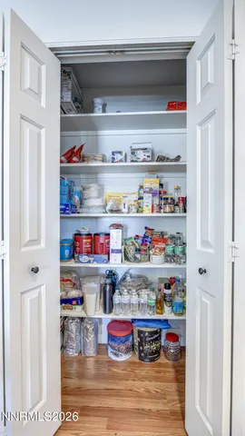 a cabinet with white wooden cabinets