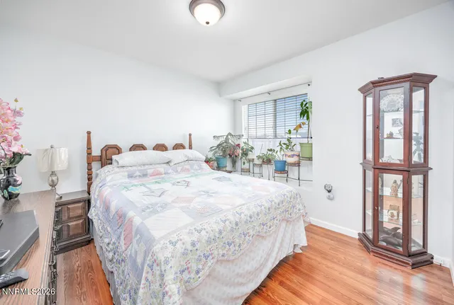 a bed sitting in a bedroom next to a window