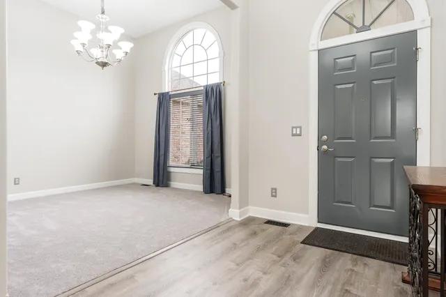 an empty room with furniture and a fireplace