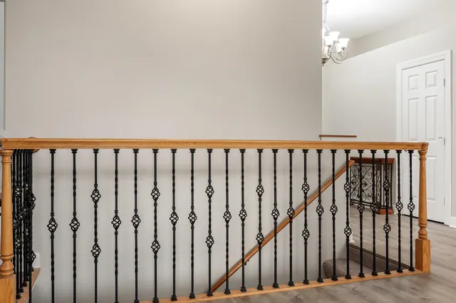 a kitchen with a sink a center island a stove and a wooden floor