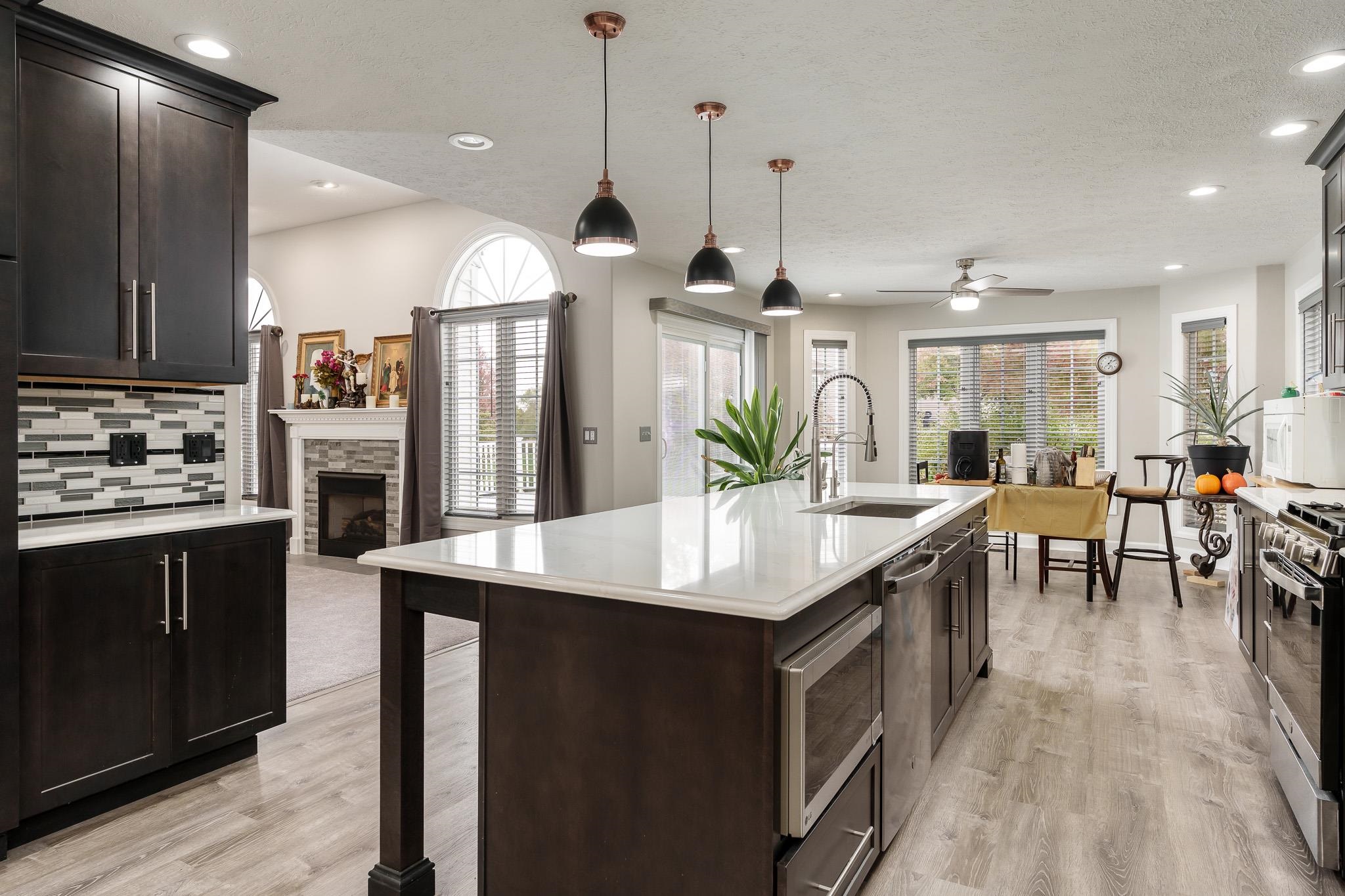 664 Elberon Way Roscoe, IL 61073 - Photo 22 of 63 a kitchen with lots of counter space a sink appliances and dining table