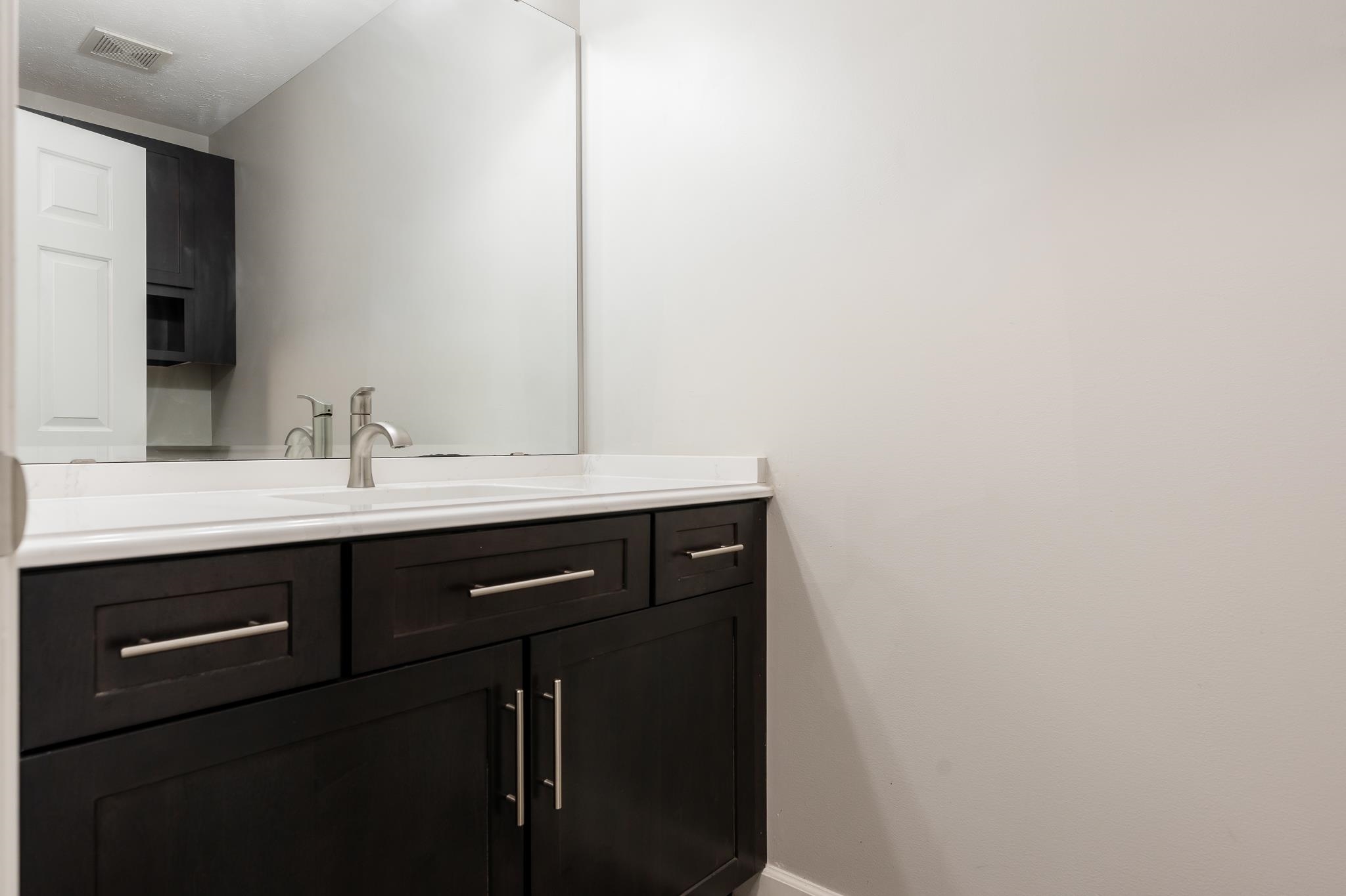 664 Elberon Way Roscoe, IL 61073 - Photo 25 of 63 a bathroom with a sink and a mirror