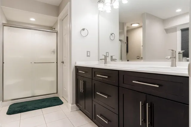 a view of an empty room with ceiling fan and window