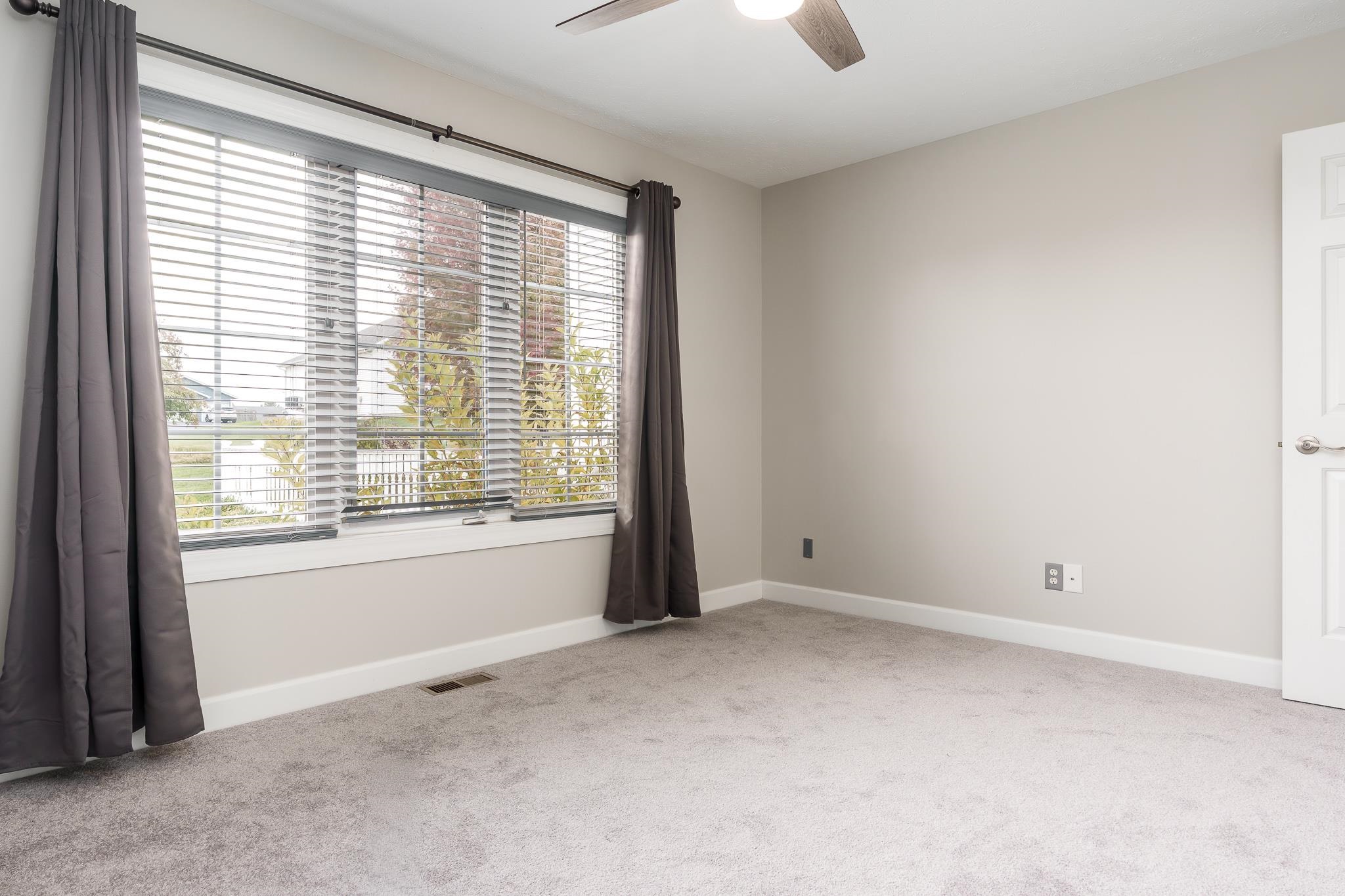 664 Elberon Way Roscoe, IL 61073 - Photo 33 of 63 a view of an empty room with ceiling fan and window