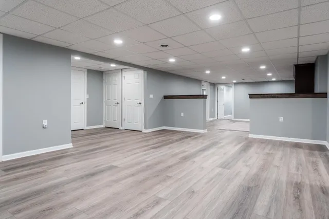 an empty room with a empty space and windows