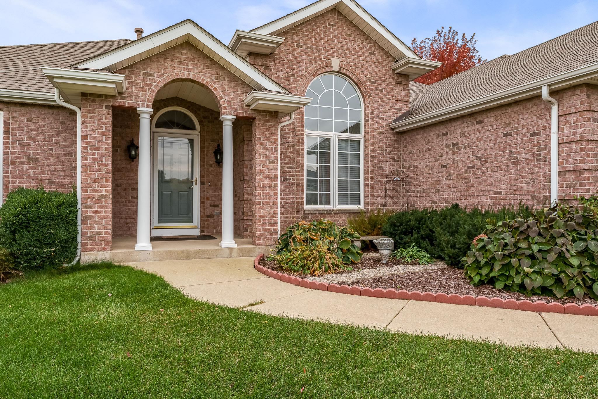 664 Elberon Way Roscoe, IL 61073 - Photo 4 of 63 a front view of a house with a garden