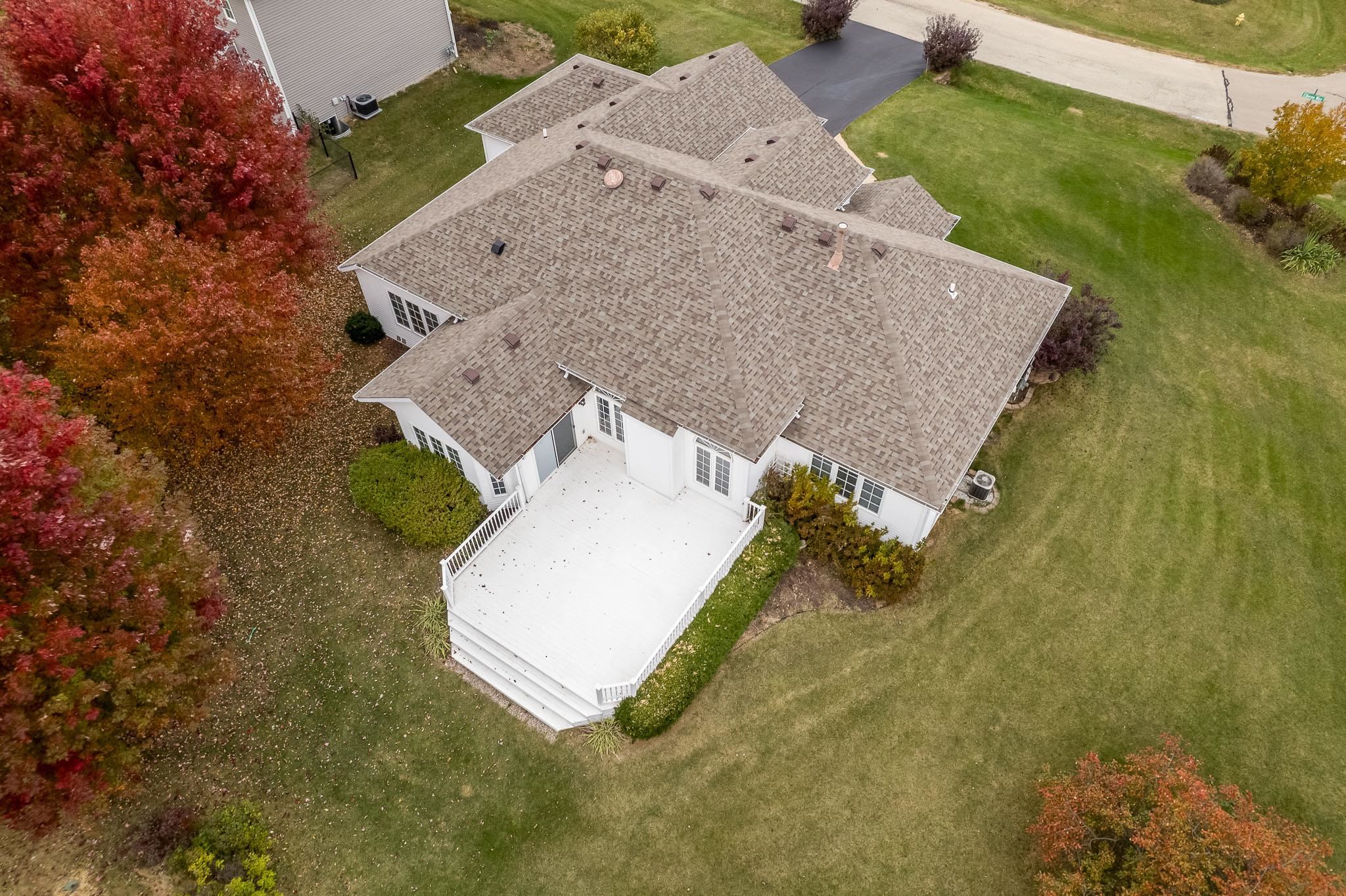 664 Elberon Way Roscoe, IL 61073 - Photo 5 of 63 an aerial view of a house with a yard and trees all around