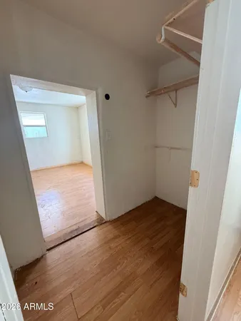 an empty room with wooden floor and door