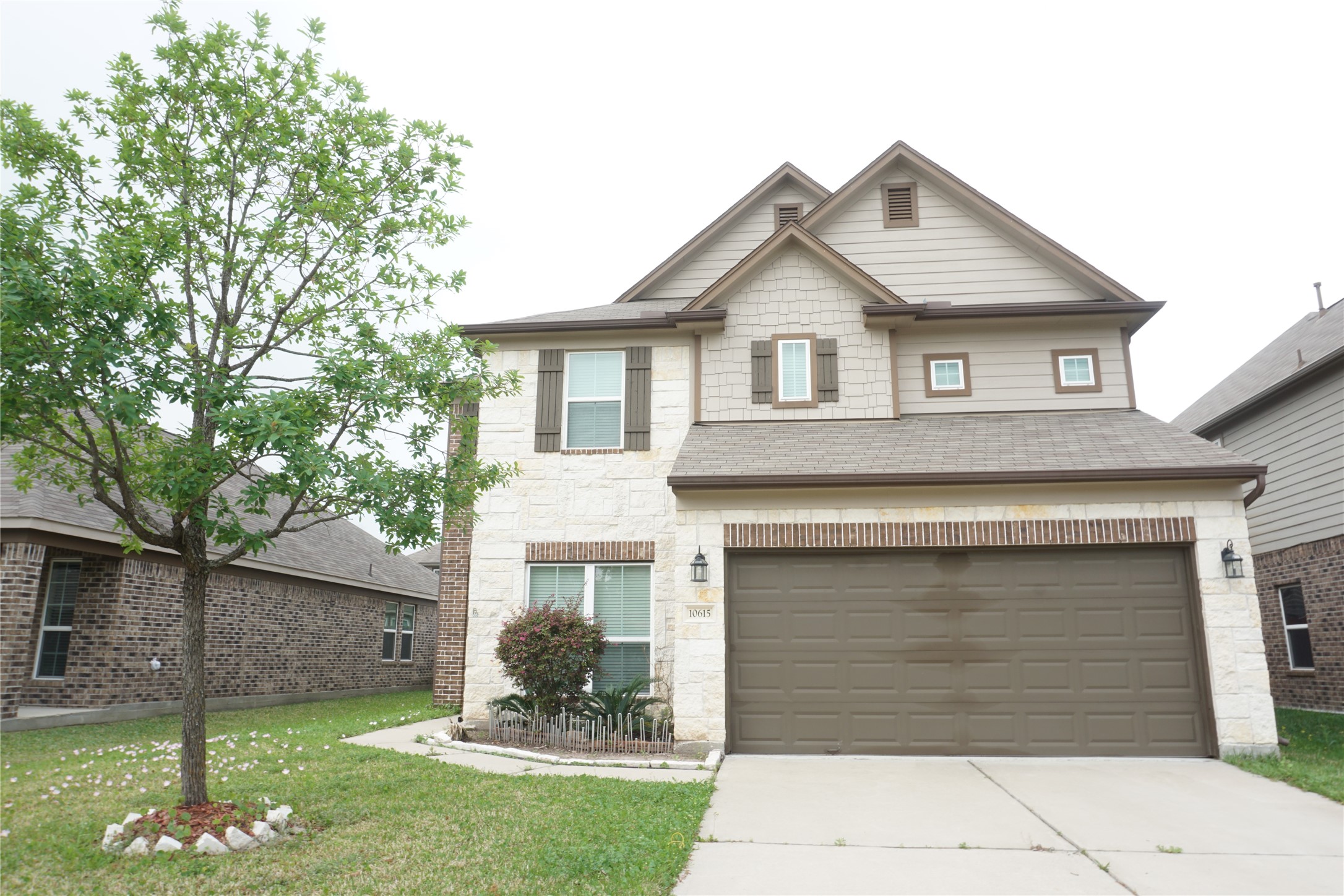 a front view of a house with a yard and garage