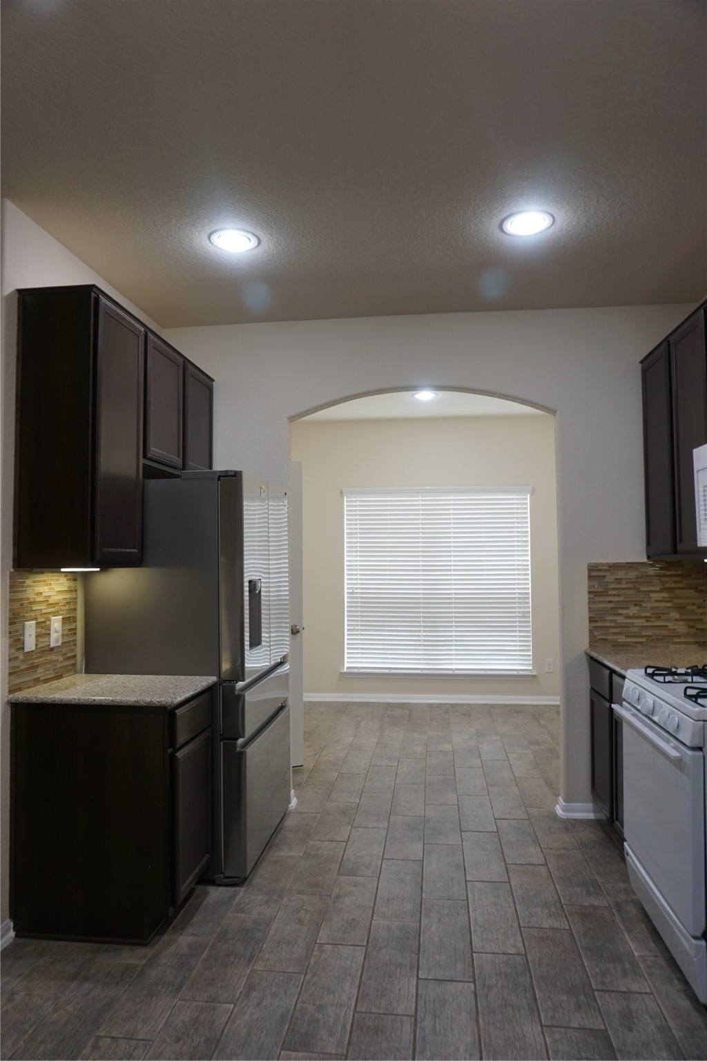 10615 North Chestnut Street Tomball, TX 77375 - Photo 14 of 15 a kitchen with stainless steel appliances granite countertop a refrigerator and a stove