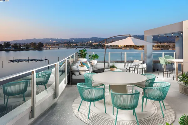 a balcony with furniture and umbrella