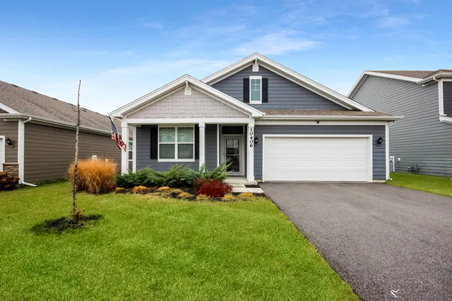 a front view of a house with a yard and porch