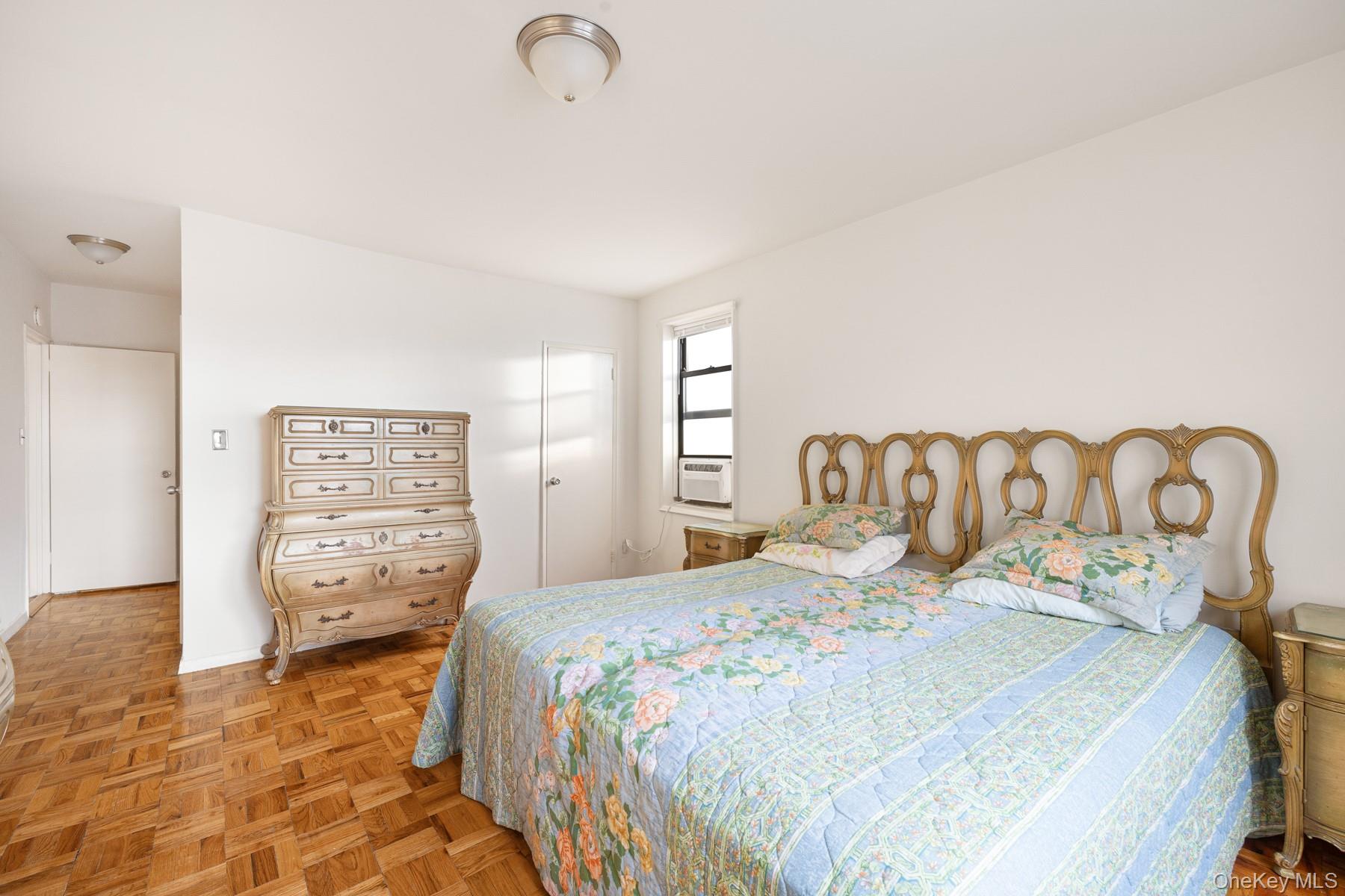 3130 Grand Concourse, Unit 2J Bronx, NY 10458 - Photo 14 of 27 a bedroom with a bed and a view of bathroom