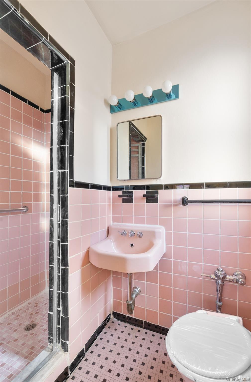 3130 Grand Concourse, Unit 2J Bronx, NY 10458 - Photo 22 of 27 a bathroom with a sink toilet and shower