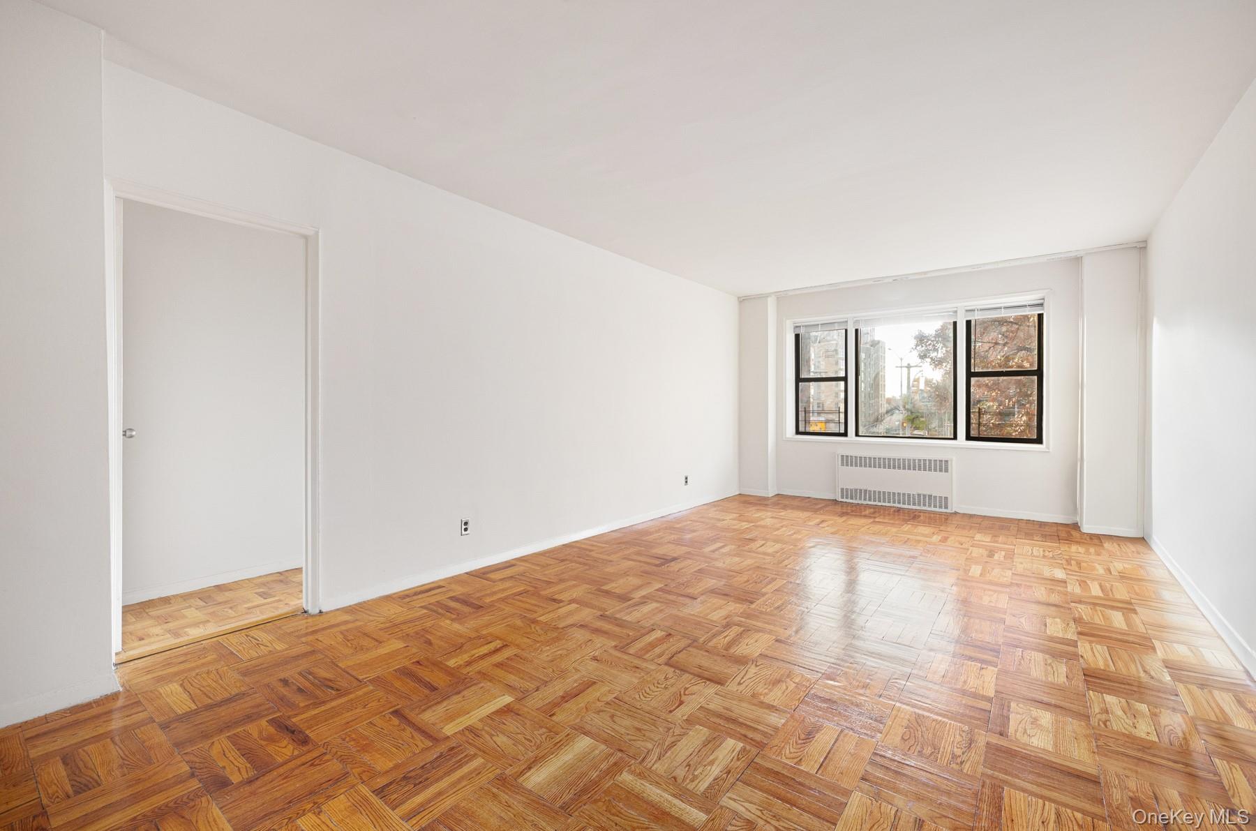 3130 Grand Concourse, Unit 2J Bronx, NY 10458 - Photo 5 of 27 a view of empty room with wooden floor