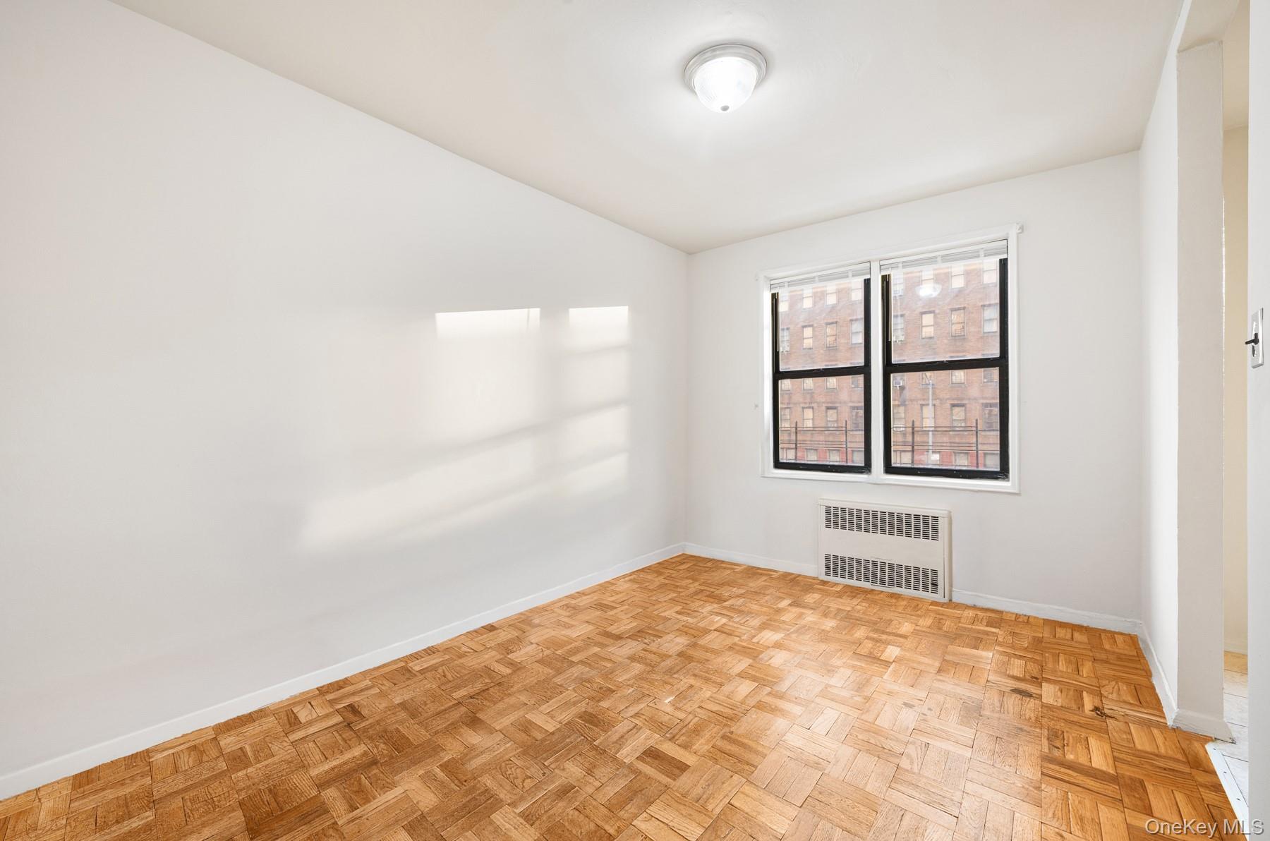 3130 Grand Concourse, Unit 2J Bronx, NY 10458 - Photo 9 of 27 an empty room with windows