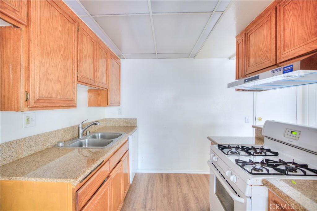 4853 Jackson Street, Unit C Riverside, CA 92503 - Photo 11 of 26 a kitchen that has a sink and a stove