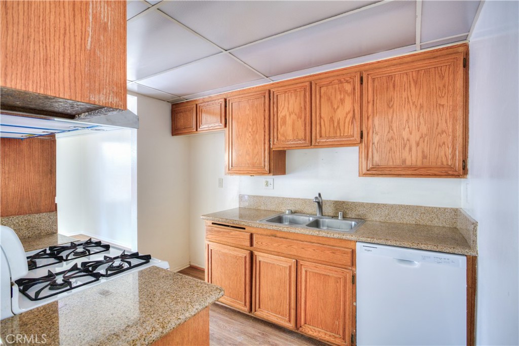 4853 Jackson Street, Unit C Riverside, CA 92503 - Photo 12 of 26 a kitchen with stainless steel appliances granite countertop a sink stove and refrigerator