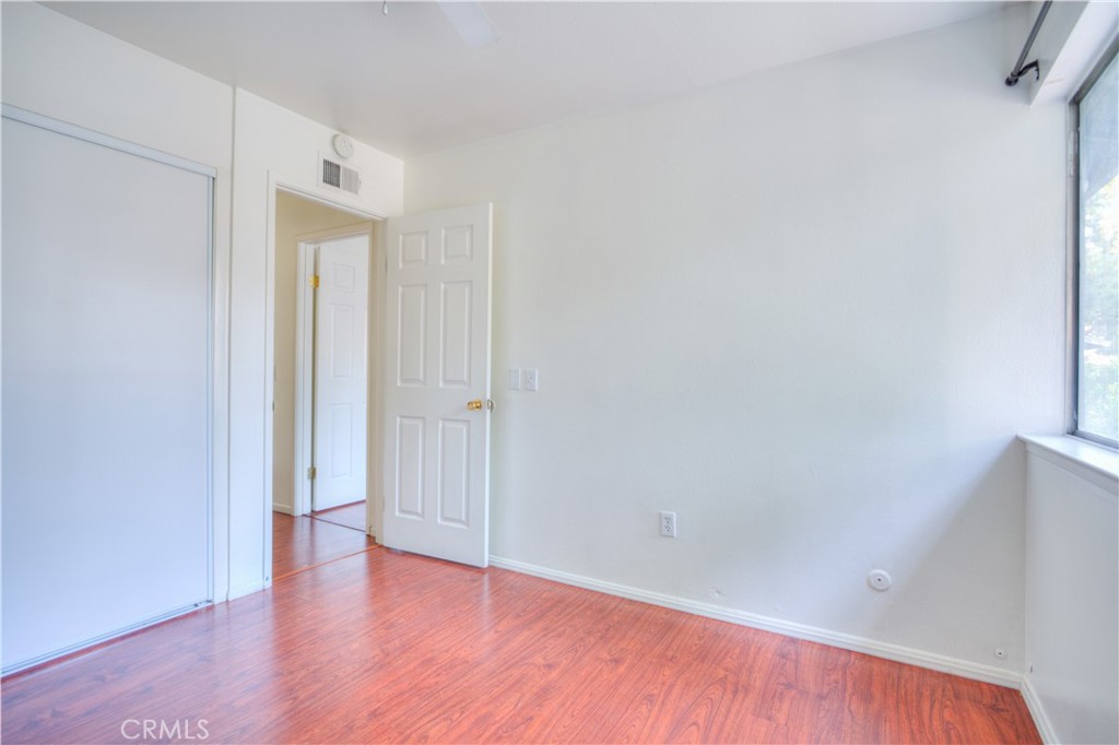 4853 Jackson Street, Unit C Riverside, CA 92503 - Photo 18 of 26 a view of an empty room with wooden floor