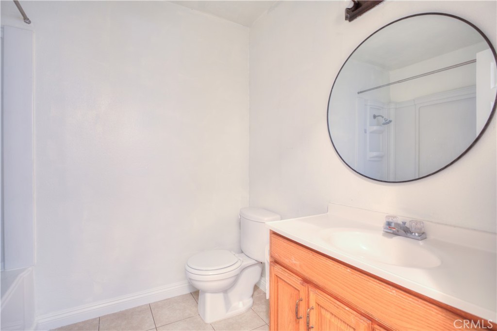 4853 Jackson Street, Unit C Riverside, CA 92503 - Photo 23 of 26 a bathroom with a sink a toilet and a mirror