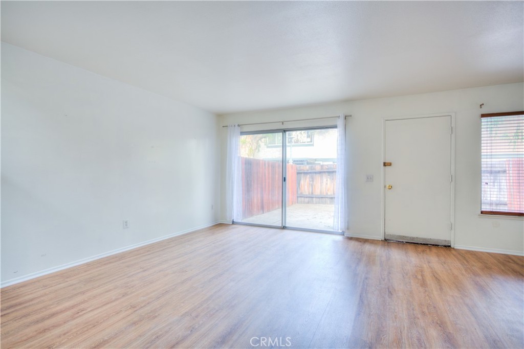4853 Jackson Street, Unit C Riverside, CA 92503 - Photo 4 of 26 an empty room with wooden floor and windows