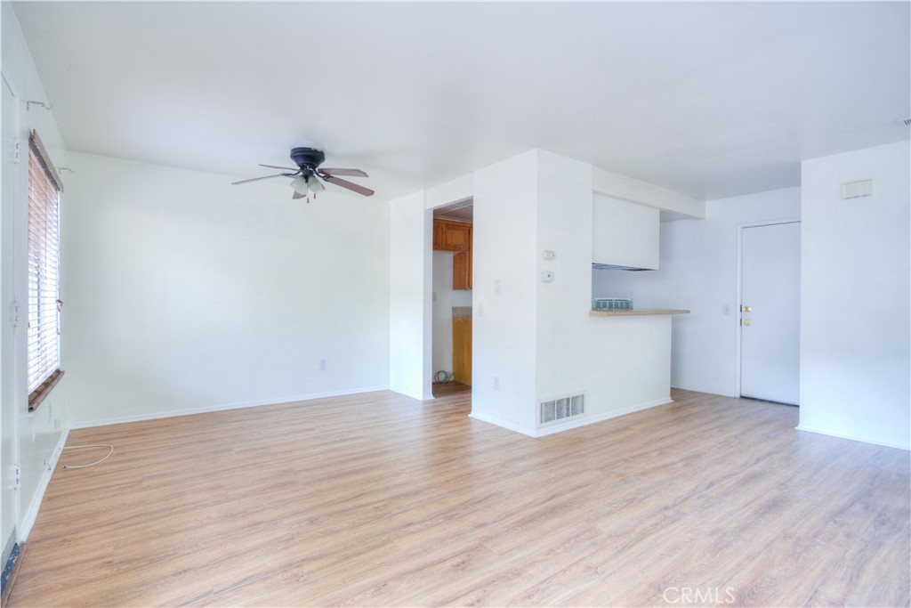 4853 Jackson Street, Unit C Riverside, CA 92503 - Photo 5 of 26 a view of empty room with wooden floor and a window