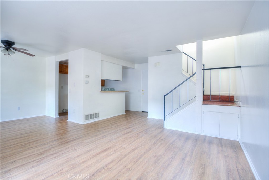 4853 Jackson Street, Unit C Riverside, CA 92503 - Photo 7 of 26 a view of empty room with wooden floor and kitchen